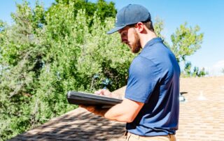 Premier Roofing technician performing a roof inspection